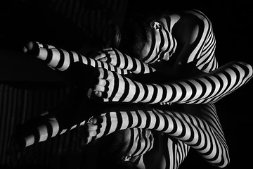 Image showing The nude woman with black and white zebra stripes