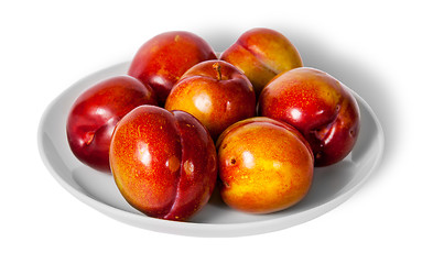 Image showing Red and yellow plums on white plate