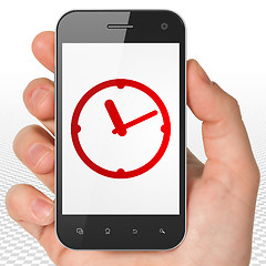 Image showing Time concept: Hand Holding Smartphone with Clock on display