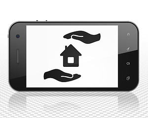 Image showing Insurance concept: Smartphone with House And Palm on display