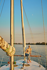 Image showing Woman traveling by boat at sunset