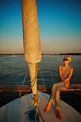 Image showing Woman traveling by boat at sunset