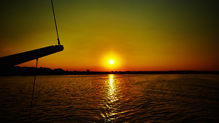 Image showing Sail boat gliding in sea at sunset