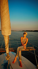 Image showing Woman traveling by boat at sunset