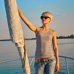 Image showing Woman traveling by boat at sunset