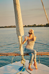 Image showing Pretty young female tourist makes selfie on yacht