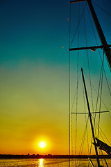 Image showing Sail boat gliding in sea at sunset