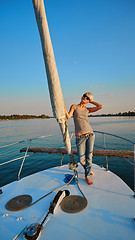 Image showing Woman traveling by boat at sunset