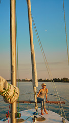 Image showing Woman traveling by boat at sunset