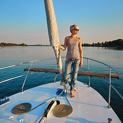 Image showing Woman traveling by boat at sunset