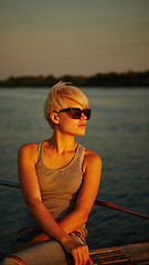 Image showing Woman traveling by boat at sunset