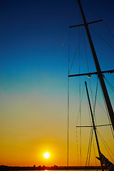 Image showing Sail boat gliding in sea at sunset