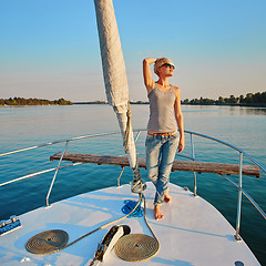 Image showing Woman traveling by boat at sunset