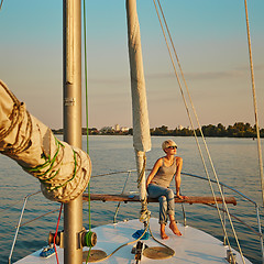 Image showing Woman traveling by boat at sunset