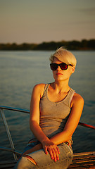 Image showing Woman traveling by boat at sunset