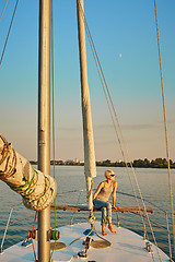 Image showing Woman traveling by boat at sunset