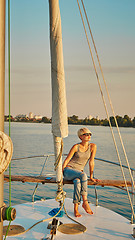 Image showing Woman traveling by boat at sunset