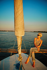 Image showing Woman traveling by boat at sunset