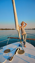 Image showing Woman traveling by boat at sunset