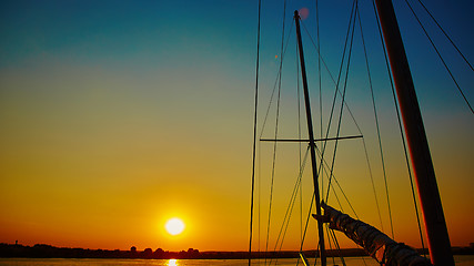 Image showing Sail boat gliding in sea at sunset