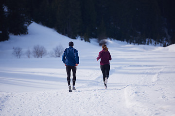 Image showing couple jogging outside on snow