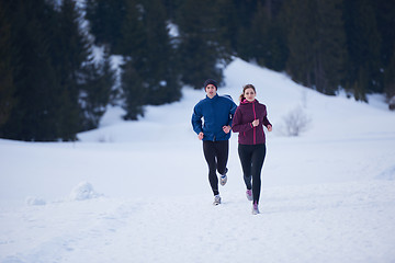 Image showing couple jogging outside on snow