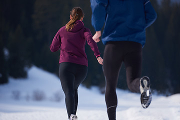 Image showing couple jogging outside on snow