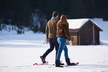 Image showing couple having fun and walking in snow shoes