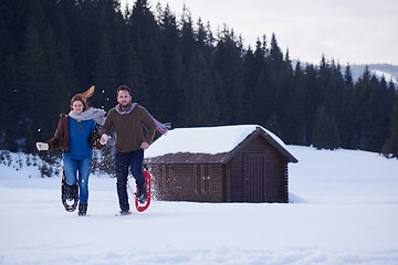 Image showing couple having fun and walking in snow shoes