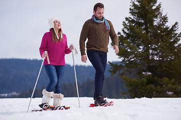 Image showing couple having fun and walking in snow shoes