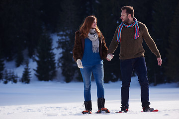 Image showing couple having fun and walking in snow shoes