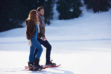 Image showing couple having fun and walking in snow shoes