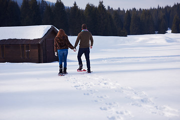 Image showing couple having fun and walking in snow shoes