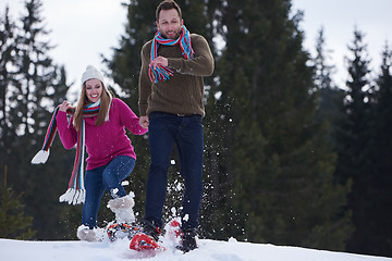 Image showing couple having fun and walking in snow shoes