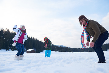 Image showing happy family playing together in snow at winter