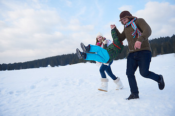 Image showing happy family playing together in snow at winter