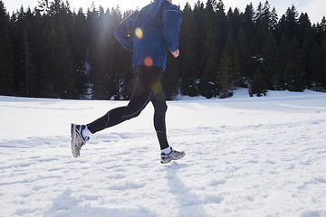 Image showing jogging on snow in forest