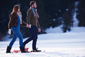 Image showing couple having fun and walking in snow shoes