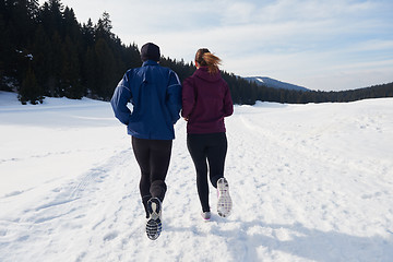 Image showing couple jogging outside on snow