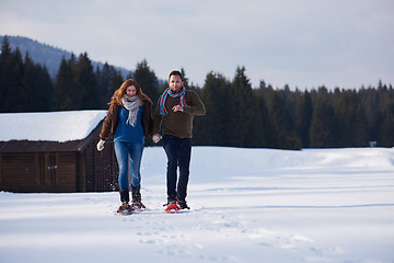 Image showing couple having fun and walking in snow shoes