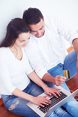 Image showing relaxed young couple working on laptop computer at home