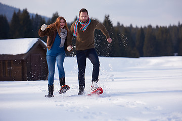 Image showing couple having fun and walking in snow shoes