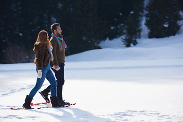 Image showing couple having fun and walking in snow shoes