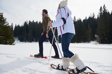 Image showing couple having fun and walking in snow shoes