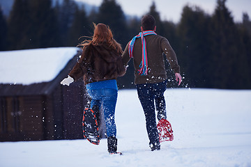 Image showing couple having fun and walking in snow shoes