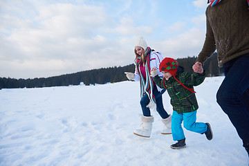 Image showing happy family playing together in snow at winter