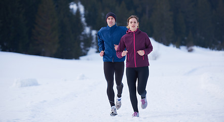 Image showing couple jogging outside on snow