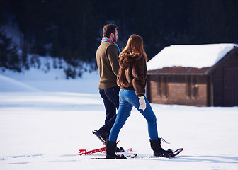 Image showing couple having fun and walking in snow shoes