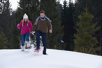 Image showing couple having fun and walking in snow shoes