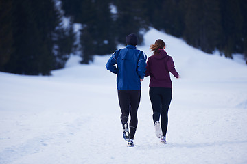 Image showing couple jogging outside on snow